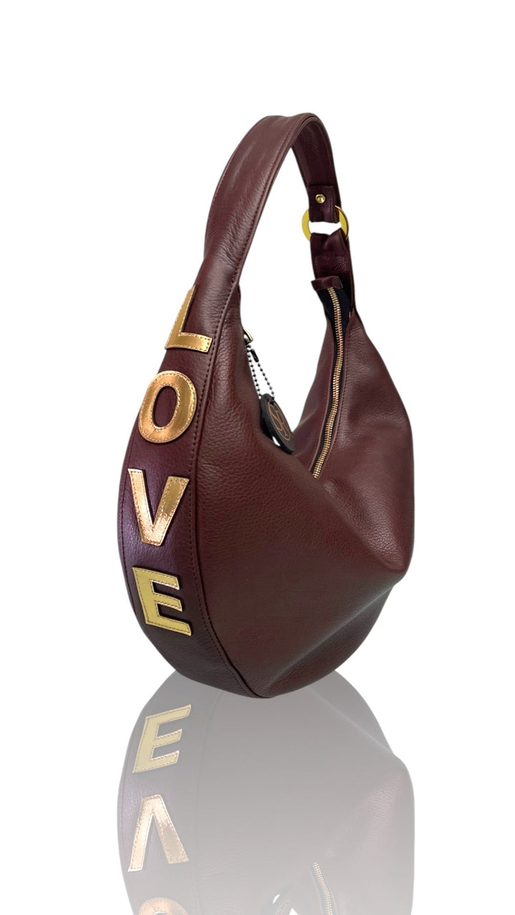 Chocolate Ramones Shoulder Bag in buttery half‑moon shape with gold appliqué and luxury zipper