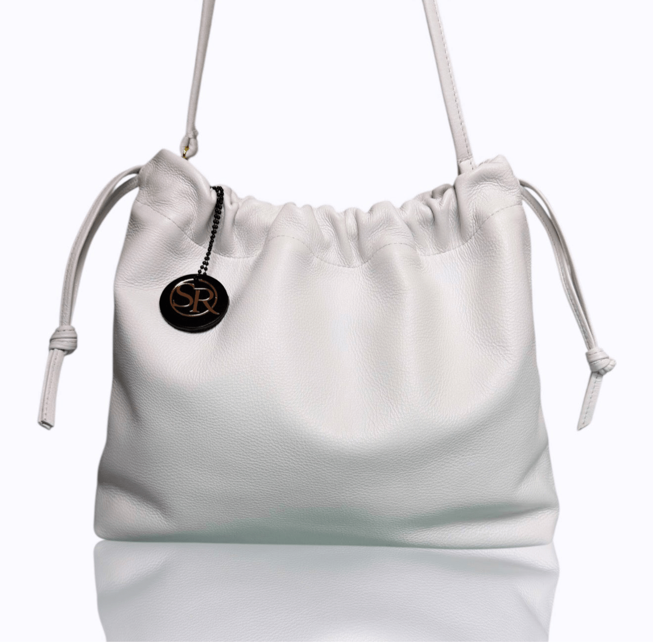 White leather drawstring bag from the Cocteau Collection with clean lines and matte finish